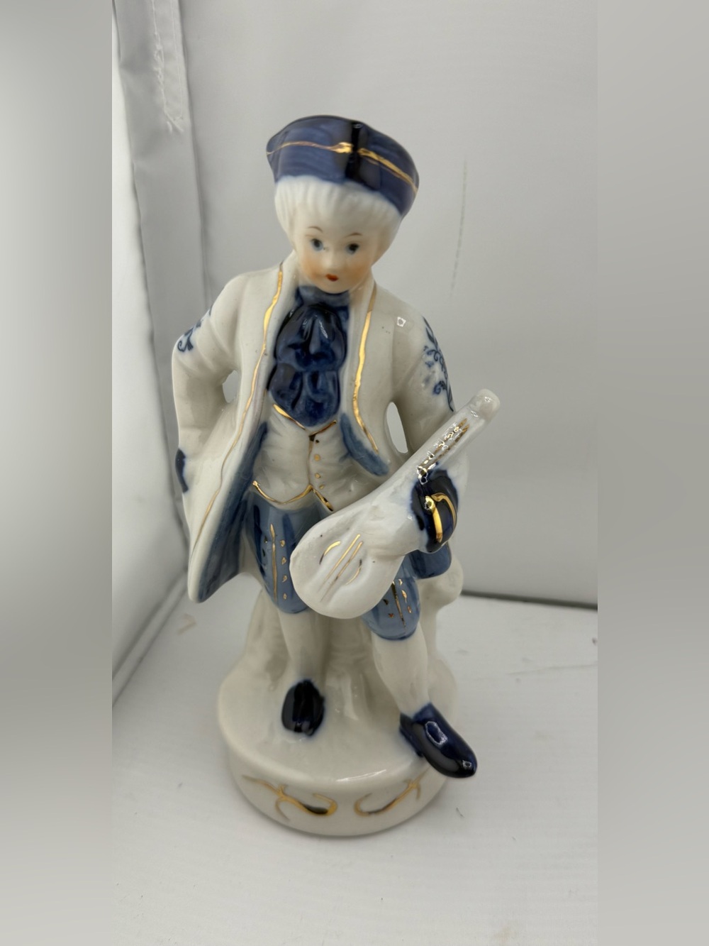 Vintage Blue and White Porcelain Musician Figurine with Gold Accents